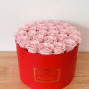 Pink roses arranged in a red round box