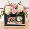 Pink roses and white hydrangeas in a black display box