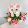 Heart-shaped white flower arrangement with pink bows and roses in a pink box