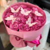 Pink rose bouquet wrapped in pink paper with butterfly decorations