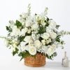 White roses and daisies arranged in a woven basket