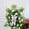 Express your heartfelt condolences with our Peaceful Memories White Carnation Standing Spray