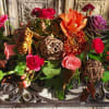 Mixed bouquet with orange, pink, and red flowers and greenery