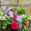 Mixed bouquet with a bright pink rose and purple and white flowers