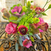 Bouquet of pink roses and green blooms in a vase