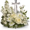 White floral arrangement with a silver cross centerpiece