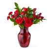 Red roses and carnations in a red glass vase