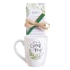 White mug with a notepad and pen tied on top