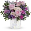 Pink roses and purple flowers in a patterned vase