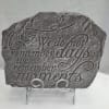 Gray memorial plaque on a metal stand with butterfly accents