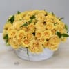 Over two dozen joyful yellow Roses in a round vase. These bright