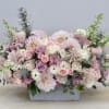 Pastel floral arrangement in a rectangular gray vase