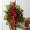 Tall red rose and gladiolus funeral spray with a red ribbon