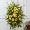 Yellow flowers and roses arranged on a standing spray easel