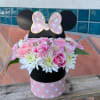 Pink and white flower arrangement in a Minnie Mouse box