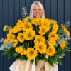 Large bouquet of yellow sunflowers with eucalyptus and ribbon in a basket