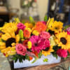 Mixed bouquet with sunflowers, roses, and lilies in a white box