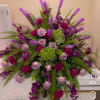 Large bouquet of purple and pink roses with green hydrangeas and fern fronds