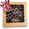 Box of chocolate-covered pretzels with a red ribbon bow