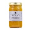 Jar of bee pollen honey with a gold lid and label