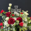 Red and white floral arrangement with a clear glass cross centerpiece