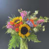 Sunflower and rose bouquet in a clear glass vase