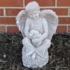 A concrete boy angel holding dog. 16"