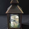 Decorative lantern with a candle and memorial text