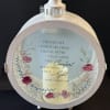 Round memorial lantern with a candle and floral design on the glass