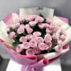 A dense cluster of soft pink spray roses makes a quietly romantic