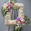 Large floral number-shaped arrangement with white, pink, and purple flowers
