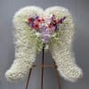 Large white floral standing spray with pink and purple roses and orchids
