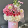 Pink and white bouquet in a pink hat box with a ribbon