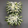 White floral standing spray on an easel