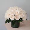 Cream rose bouquet in a dark glass vase