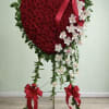 This beautiful heart spray combines classic red roses with elegant white orchids