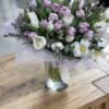 Bouquet of pink and white tulips in a glass vase