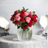 A lush cluster of red and pink roses makes a bold, romantic