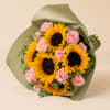 Bouquet of yellow sunflowers and pink roses wrapped in green paper