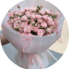 A lush, rounded hand-tied bouquet of pale pink spray roses that reads