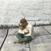 Small figurine of a person holding a child