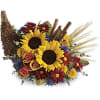 Sunflower and rose bouquet with daisies and wheat in a wicker basket