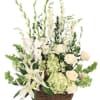 White floral arrangement in a wicker basket with tall stems
