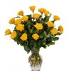 Tall arrangement of yellow roses in a clear glass vase