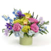 Delicate pastel blooms in lavender, blues, and soft greens, arranged with an
