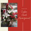 Beautiful custom design of seasonal greens, flowers and decor in a vase