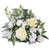 White roses and daisies arranged around a clear glass cross