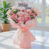 Pink bouquet with roses and hydrangeas, wrapped in pale pink paper with a "Miss You" card