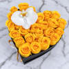 Heart-shaped box of yellow roses with a white orchid on top