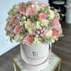 An elegant box arrangement designed in soft blush and ivory tones, overflowing